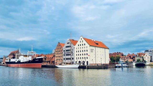 Beautiful view of Gdańsk Harbor featuring the National Maritime Museum and historic architecture.