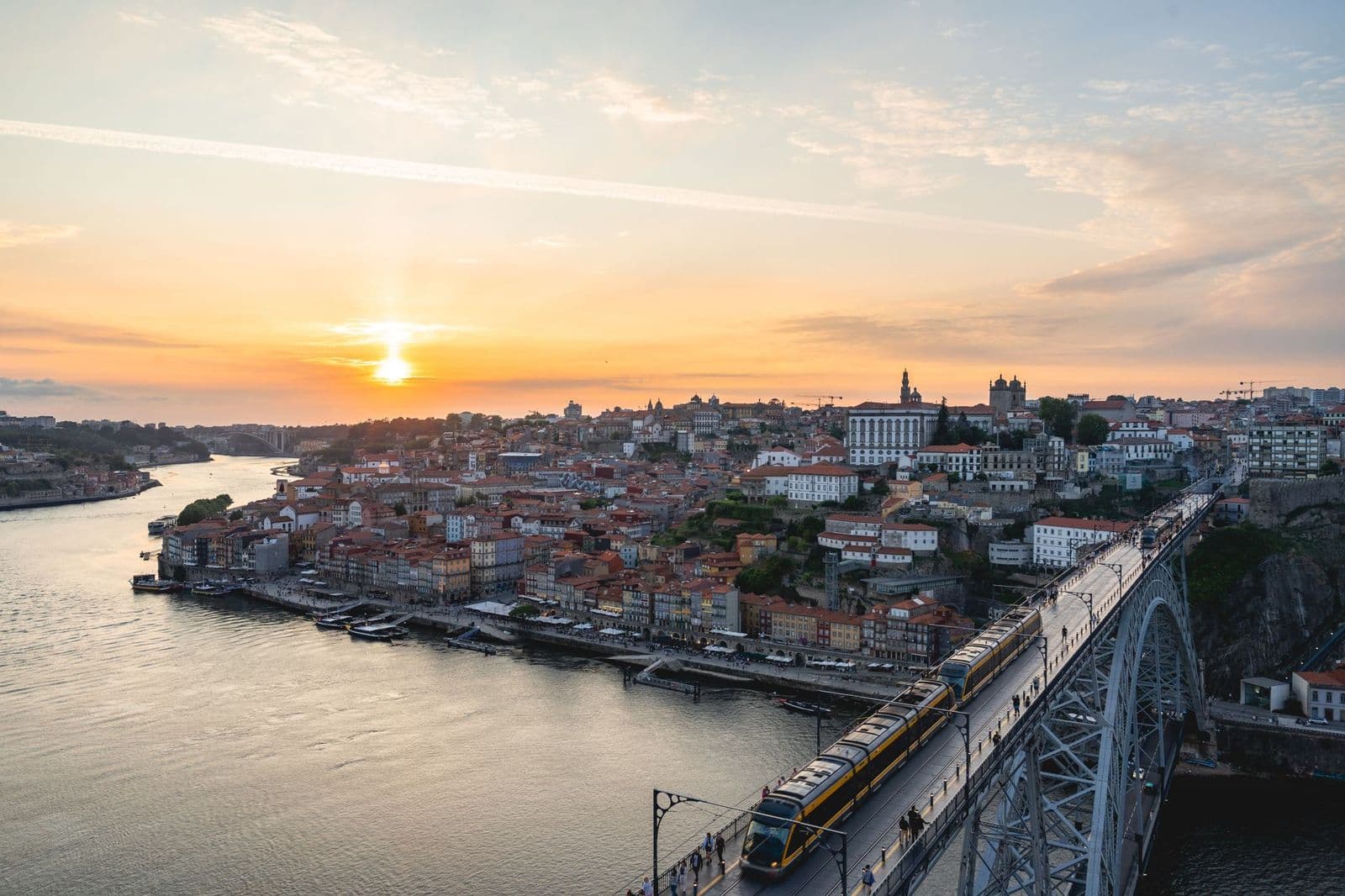 Captivating sunset over Porto with Dom Luís I Bridge and the Douro River in view.