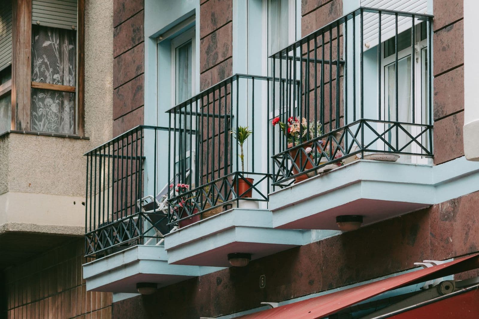Charming European balconies adorned with potted plants in San Sebastián de La Gomera, Spain.