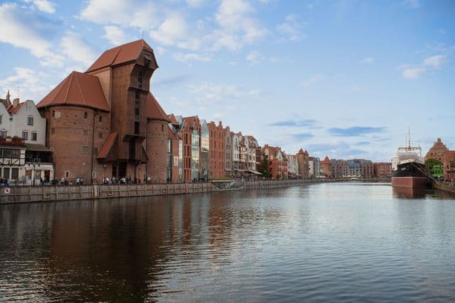 Beautiful view of Gdańsk's iconic waterfront featuring historic architecture and a moored ship.