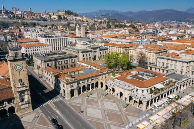 A stunning aerial view of a historic cityscape featuring red-tiled roofs and classic architecture.